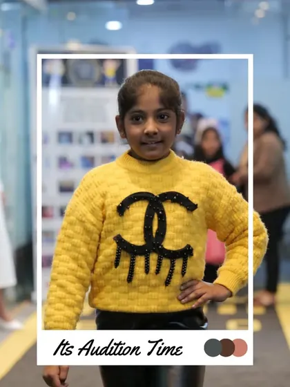 A bright yellow sweater and a confident pose make this participant memorable. Auditions are where we spot future talent.
