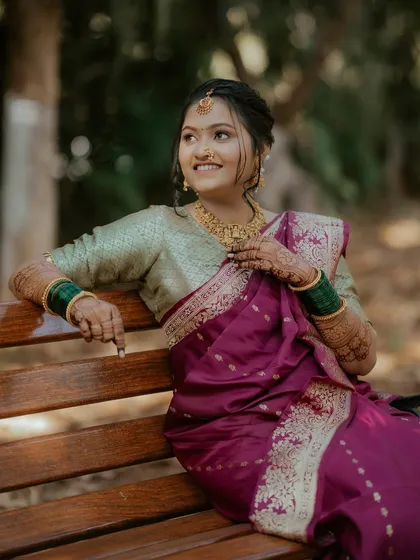 A candid moment of the bride enjoying her special day. Her makeup is designed to be long-lasting and picture-perfect, even in natural outdoor lighting.