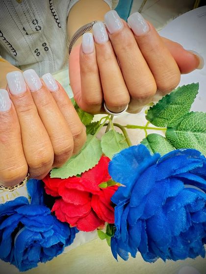 A classic set of milky white square nails, a perfect choice for any occasion.