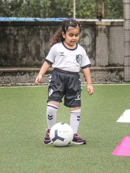 Practicing ball control through a cone drill. These simple exercises are the building blocks for developing excellent footwork and confidence for our young players in Mumbai.