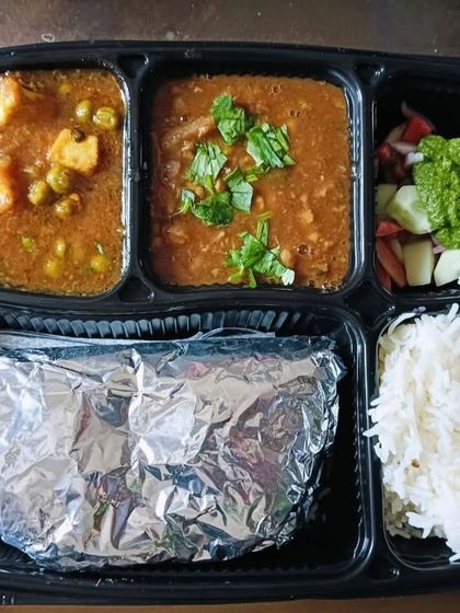 A classic thali with chana masala and matar paneer. This is a staple North Indian meal that is loved by all.