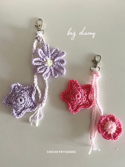 One of my newest additions, these bag charms feature a combination of a flower and a star. This image shows a purple daisy with a star and a pink star with a mini flower, all attached to a convenient clasp.