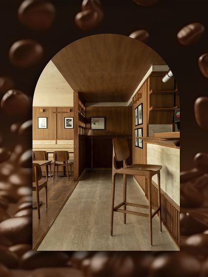 This view of Quick Brown Fox Coffee Roasters shows how the travertine surfaces create a serene and cohesive environment. The natural stone complements the warm wood, enhancing the minimalist design by Renesa Architects.