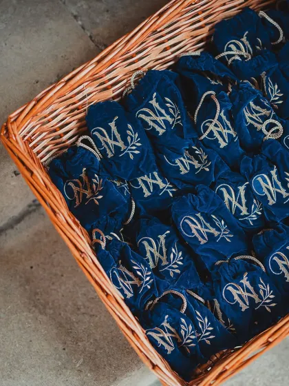 Personalized velvet pouches with the couple's monogram, a luxurious and thoughtful wedding favor.