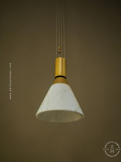 A simple yet elegant cone-shaped pendant light. The shade is crafted from marble, providing a warm, diffused downlight that is perfect for task lighting over kitchen counters, reading nooks, or as accent lighting.