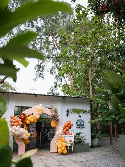 The entrance to a birthday party at Backyard, decorated with a balloon arch. This shot shows how the modern architecture of the venue works well with fun, festive decor.