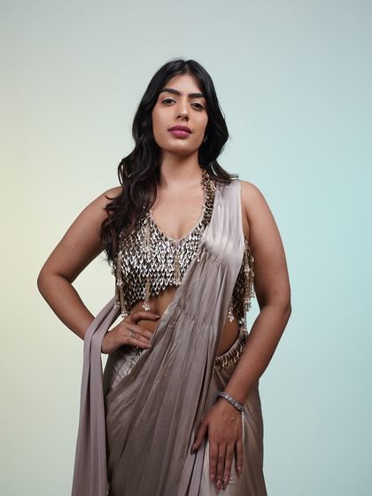 A full-length view of the metallic pre-draped saree. The unique blouse with its scale-like sequins is a true conversation starter.