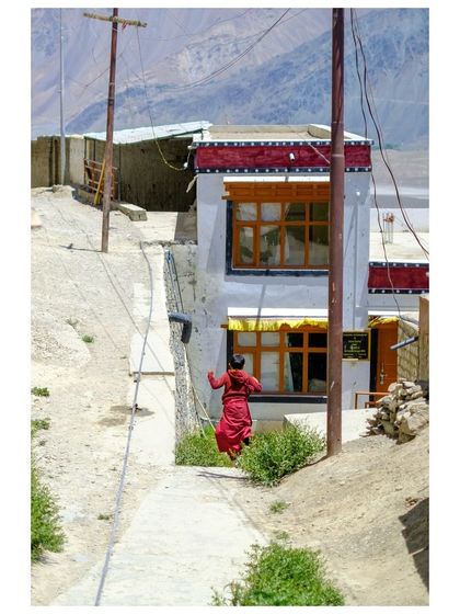 The same monk caught mid-stride, a dynamic shot capturing his movement.