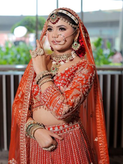 A side profile showing the flawless blending of the makeup and the neatness of the hairstyle. Every detail is taken care of.