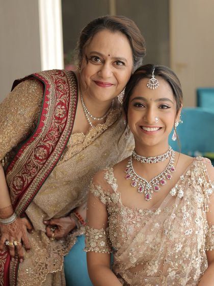 A beautiful, tender moment between a bride and her mother. The soft, natural makeup on both of them highlights their glowing skin and the love they share.