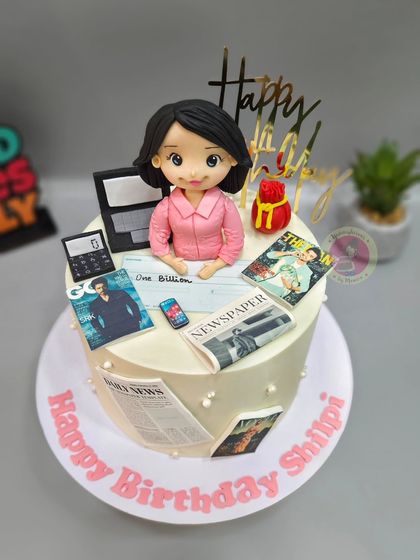 A wider view of the PR expert cake, showing all the elements that represent her busy professional life.