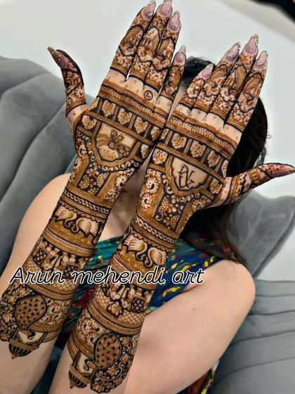 A stylish design with personalized initials and a variety of traditional animal motifs like elephants and camels.