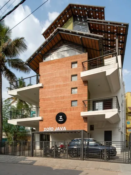 This is the completed exterior of the Earthen Spirit project, a warehouse we repurposed into a modern co-living space called Zolo Java. We added new balconies and a striking multi-layered roof structure, blending the building's industrial past with a fresh, residential feel. The final design stands as a testament to how adaptive reuse can revitalize urban structures.