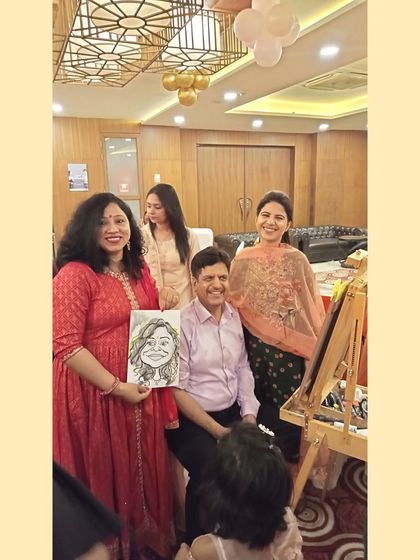 A group photo with guests and a finished caricature. My work often brings people together for a laugh and a photo.