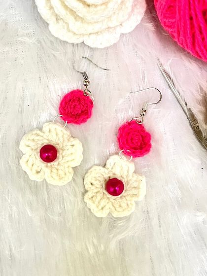 A close-up of the pink and white floral dangle earrings. I love combining different small crochet elements to create unique jewelry.