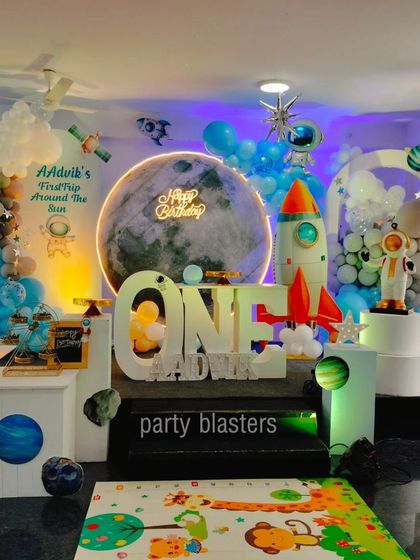 A well-lit shot of the space party decor, showing the "First Trip Around the Sun" sign and the arrangement of planets and stars.