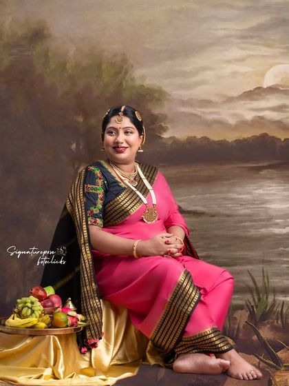 The details of the embroidered blouse and traditional jewelry are highlighted in this serene portrait.