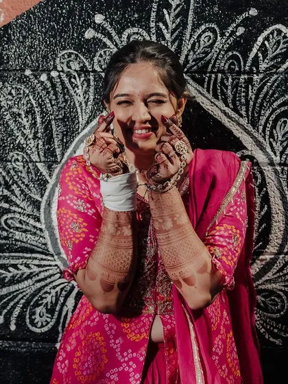 The same happy bride, her joy evident in this playful pose against a cool mural.