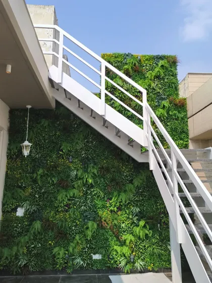 This installation in Punjabi Bagh, Delhi, shows how a green wall can transform a functional space like an outdoor staircase. The UV protective foliage ensures it stays green and vibrant for years.