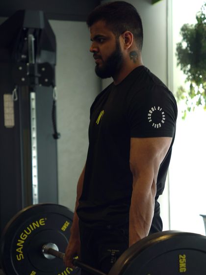 Our coach Vinay, a specialist in Olympic weightlifting and strength building, gets ready for a lift. Our trainers are active members of the community, training alongside you.