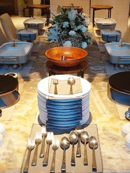 A different style of elegant table setting, using a mix of modern serveware and individual dessert cups for a clean, sophisticated look.