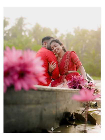 A candid moment of rest and affection on the side of the boat. The soft backlighting adds a warm glow to this romantic scene.