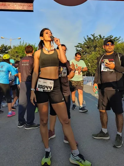 Biting the medal after a hard fought race. This moment is a reward for all the early mornings and tough miles. It's a taste of victory.