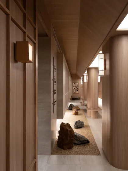 Another perspective of the rock-lined corridor, emphasizing the play of light and shadow.