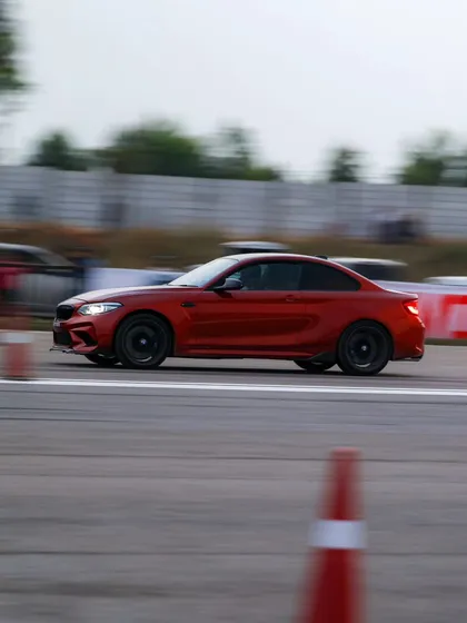 A red BMW M2 coupe, a compact performance powerhouse, captured in a motion blur. The variety of BMW's M cars at our events is always impressive.