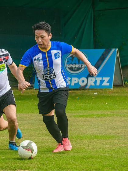 Two players race for a loose ball, demonstrating the fast pace of the games hosted at our venues.