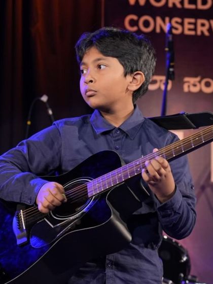 Focus and passion on display from another young guitarist in the tribute ensemble.