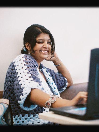 A smiling customer working on her laptop, perfectly capturing the joy of finding a great spot to be productive.