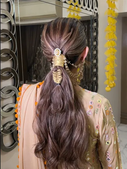 A detailed back view of the accessorized ponytail, showing the intricate weaving and wrapping that makes this style so special.
