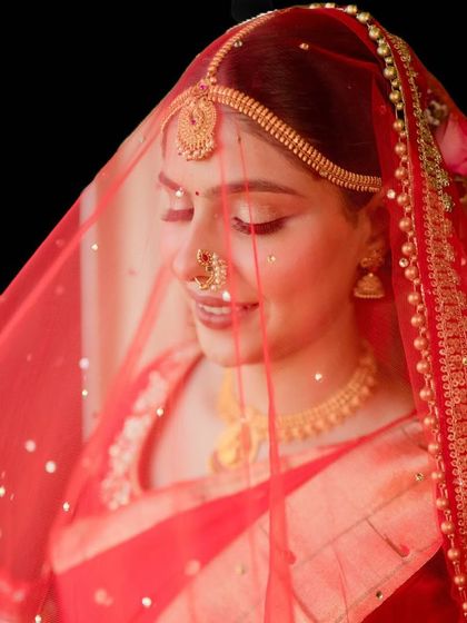 A dreamy, veiled shot of my bride. The soft makeup and traditional gold jewelry create a timeless and ethereal look, perfect for a Maharashtrian wedding.