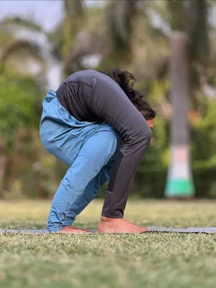 Bend, bend, bend. This is another angle of an intense forward fold, showing the deep spinal flexion involved.