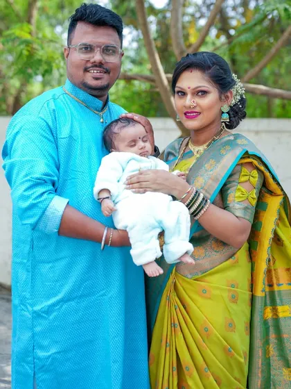 A classic family portrait with their newborn, capturing the joy and completeness of their new family of three.