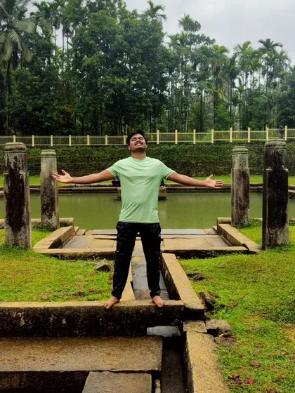 A trekker enjoying a moment of freedom at the Devagange temple complex.
