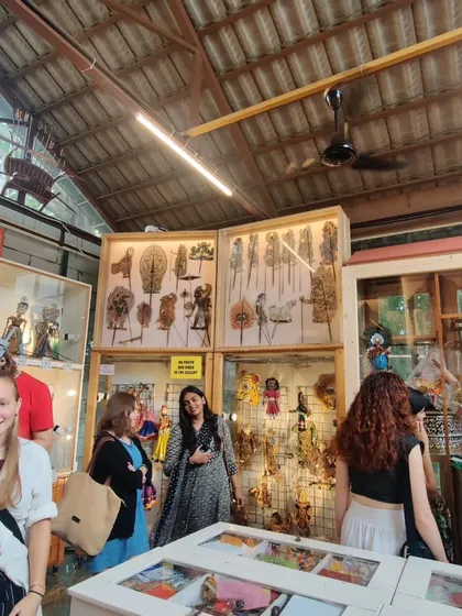Visitors exploring the Dhaatu Puppet Museum during a guided tour. Our collection is housed in well-lit display cases, allowing for a close appreciation of the diverse forms of puppetry from various Indian traditions.
