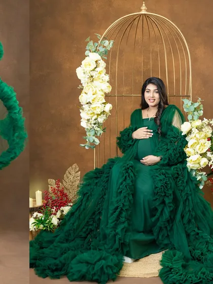 A regal seated portrait in a magnificent green ruffled gown. Our studio props, like this elegant birdcage chair and floral arrangements, help create a luxurious and sophisticated setting.