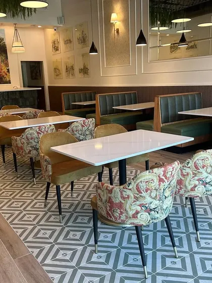 I am thrilled to have completed my first international project, a restaurant in Houston, Texas, designed entirely from my Mumbai office. This space features a mix of patterned tile floors, comfortable booth seating, and elegant, modern chairs. It was a wonderful challenge that shows my firm's capability to deliver quality design anywhere in the world.
