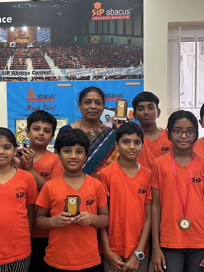 These students are beaming with pride as they show off their trophies and medals. This recognition boosts their self esteem and encourages them to continue learning.