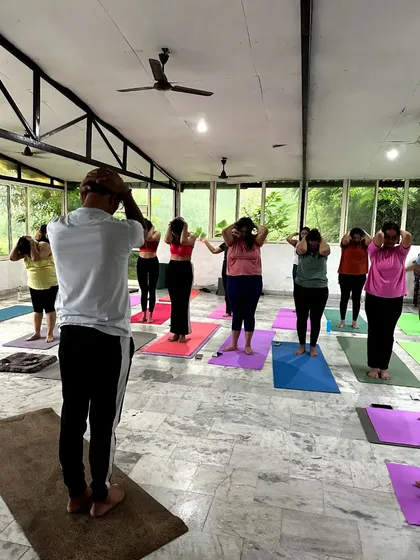 A moment from our yoga retreat in Rishikesh, where I guide the class through breathing exercises to connect with the prana in the fresh mountain air.