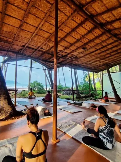 The beachside shala for our Goa retreat, a space for practice surrounded by the sounds of the ocean and rustling palms.
