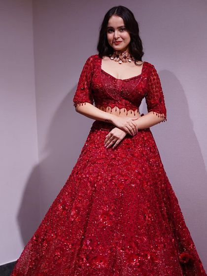 For the bride who loves glamour, this all-red lehenga is covered in sparkling sequins and intricate threadwork. It’s designed to catch the light and make you shine.