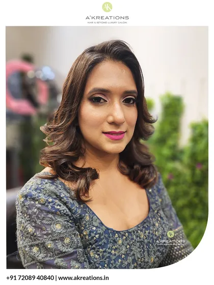 A polished party look featuring soft, bouncy curls and defined makeup. This style is perfect for owning the room at any evening event.