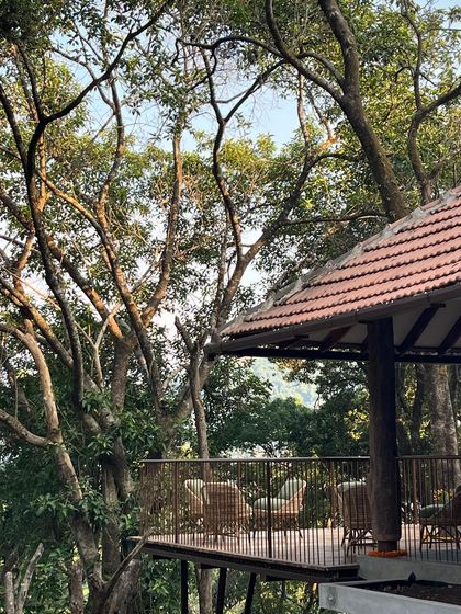 The deck of the Coorg house feels like a treehouse, cantilevered out into the canopy of the surrounding forest.