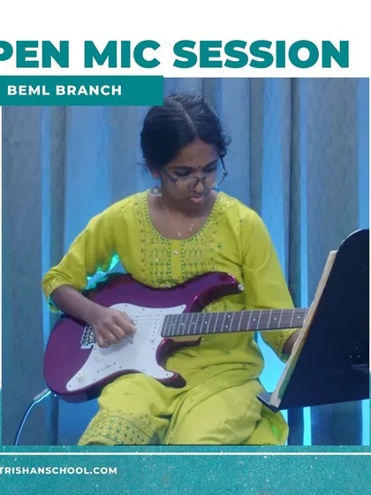 A student playing a purple electric guitar during a performance at the BEML branch.