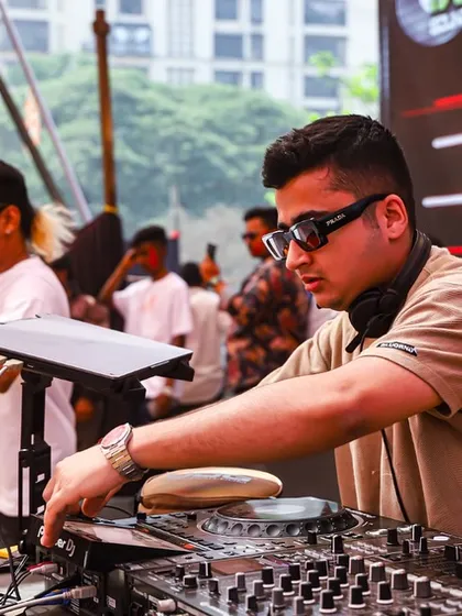Focused on the mix during a large outdoor festival. You can see a percussionist next to me, adding a live element to our massive sound.