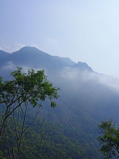 Morning mist clinging to the peaks of the Western Ghats during our Kodaikanal tour. These are the views that greet you as you begin your day's ride, promising cool weather and stunning scenery.