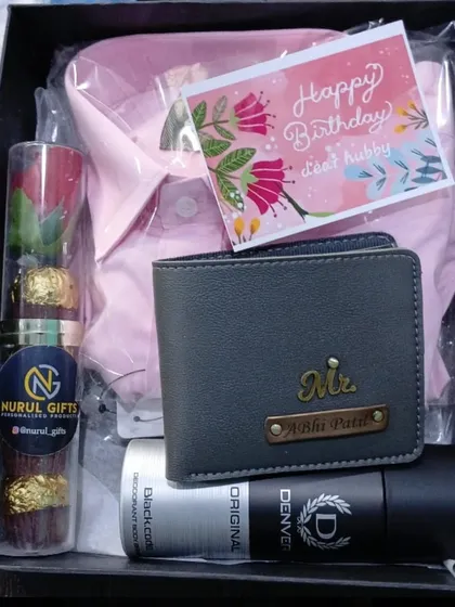 A lovely birthday hamper for a husband, with a personalized wallet, a pink shirt, deodorant, chocolates, and a heartfelt birthday card.